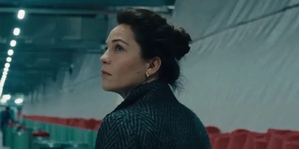 A woman looks over her shoulder. 