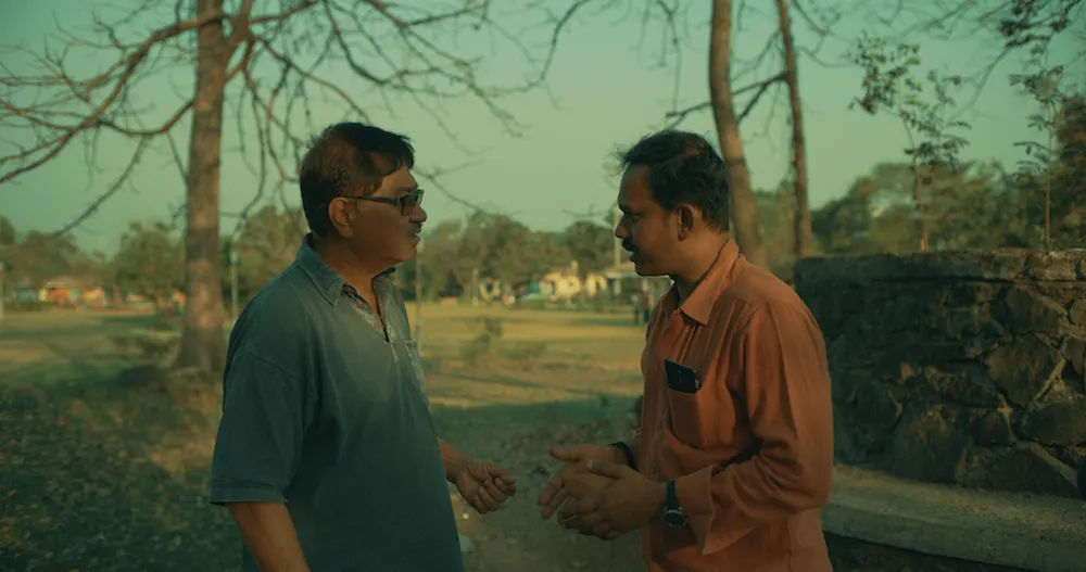 two men talking outside