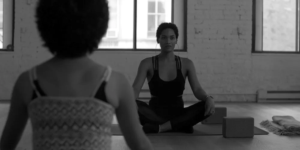 Two people doing yoga