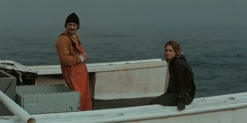 Man and woman in fishing apparel on a boat