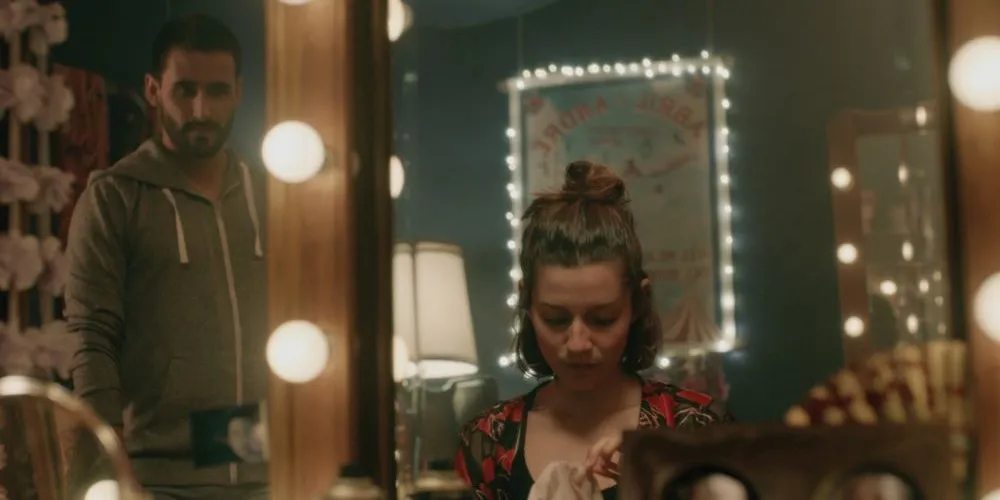 Two people viewed in mirror with lights