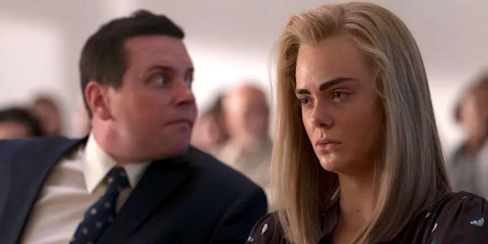 still of two characters, one looking forward the other over his shoulder