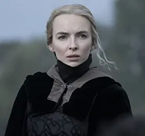 woman with pale hair in darkly colored costume