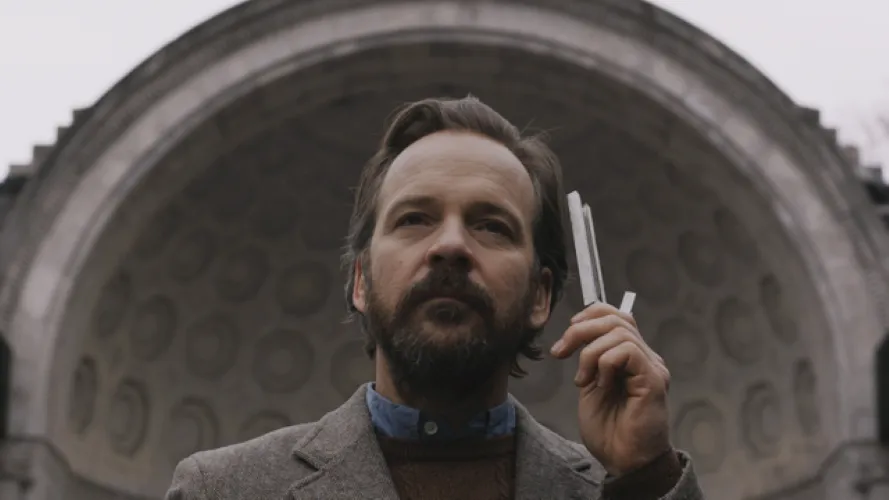 A man in front of a big building.