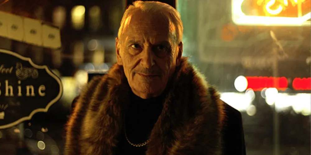 Still from 'Tight Spot', a man at night with a fur coat.