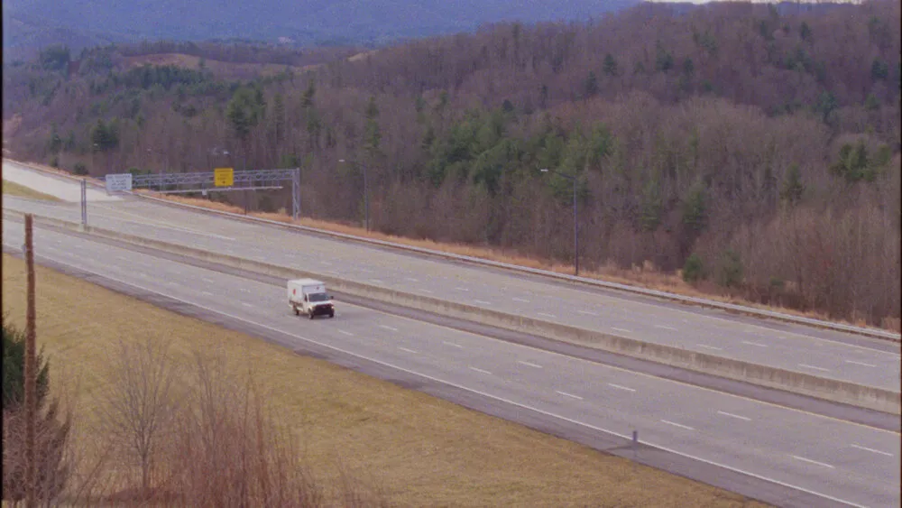 Lone truck on a forested highway