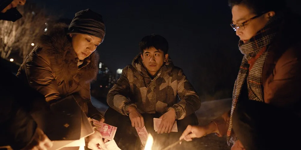 Four people around a fire