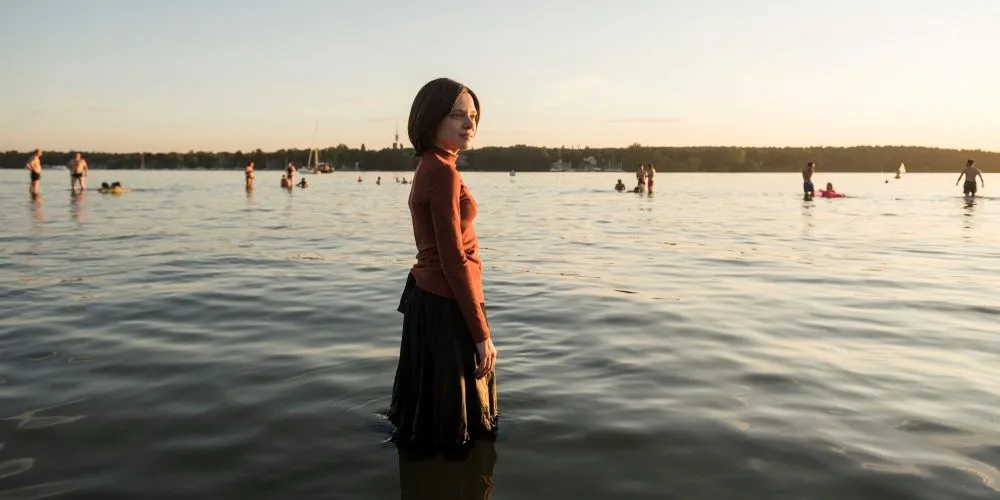 Woman standing in water at shore