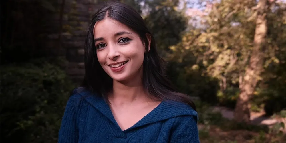 A young woman in a blue sweater