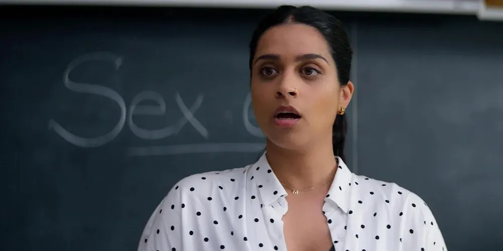 a teacher stands in front of a chalkboard