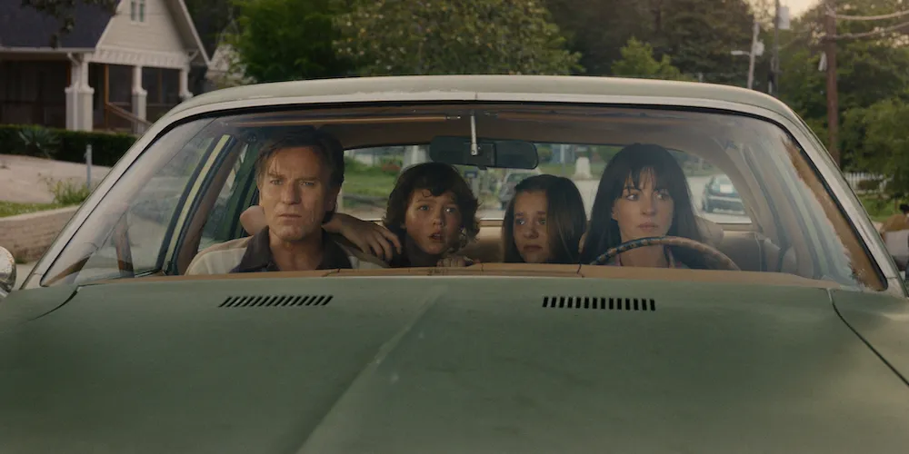 A family of four inside a car.