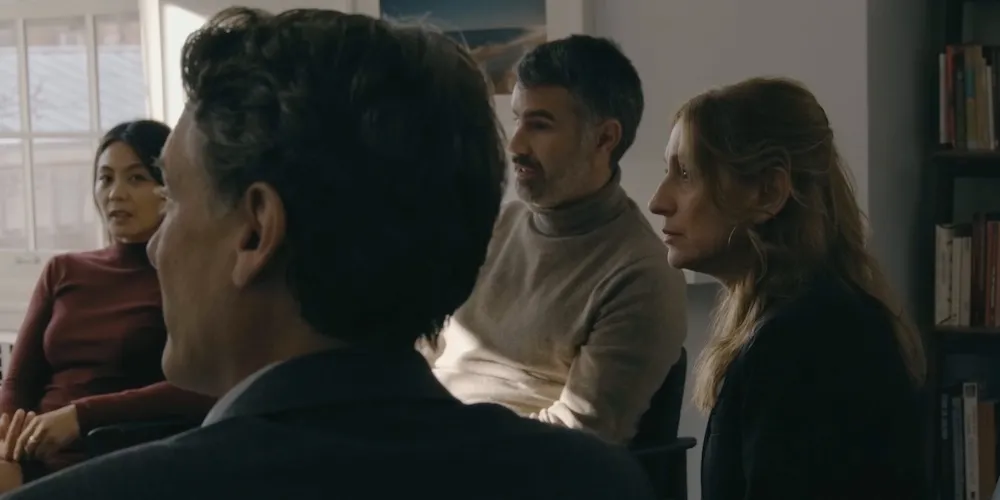 four people sit and talk