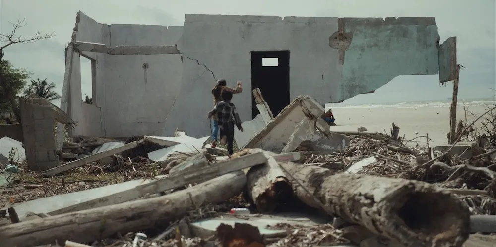 people walk amidst rubble