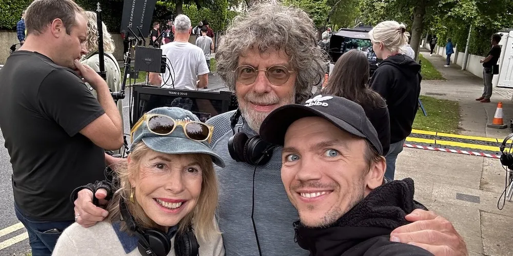 three people in front of a camera