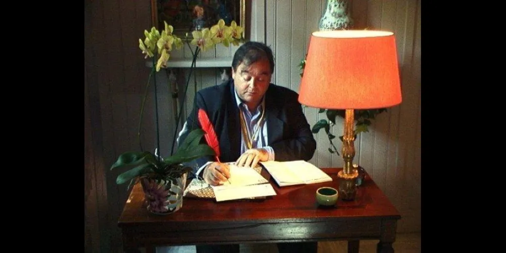 Brendan Noel Ward writing at his desk