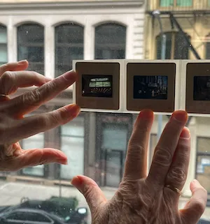 slide photographs pressed against a window