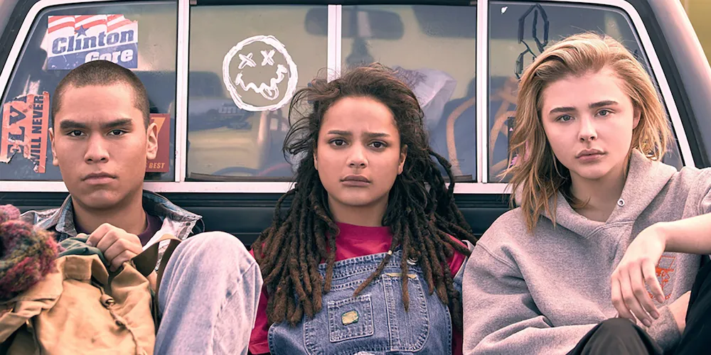 Three teenagers in the bed of a truck