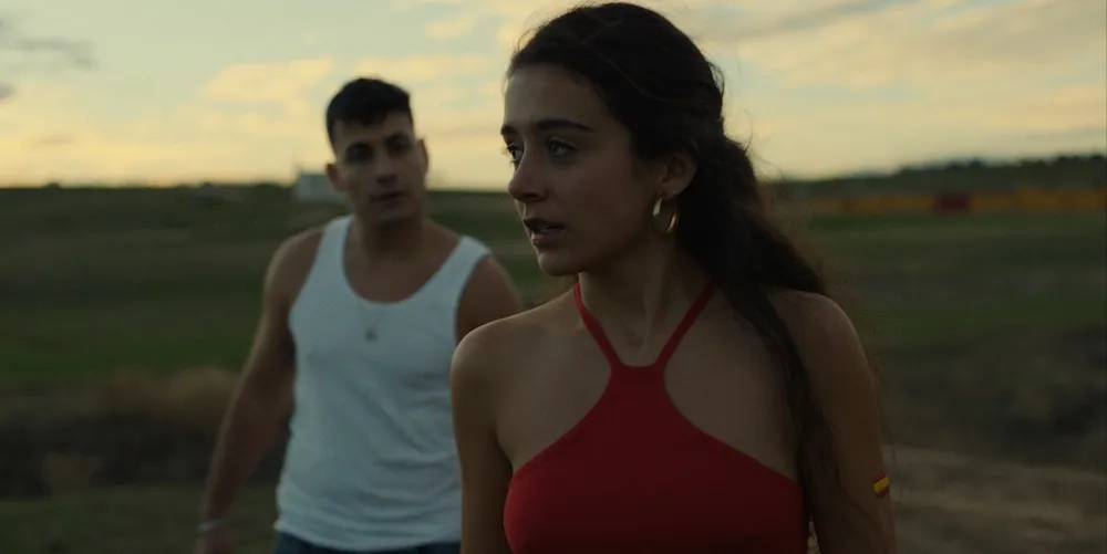 A man and woman stand in a field