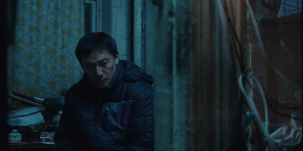 A man wears a coat inside