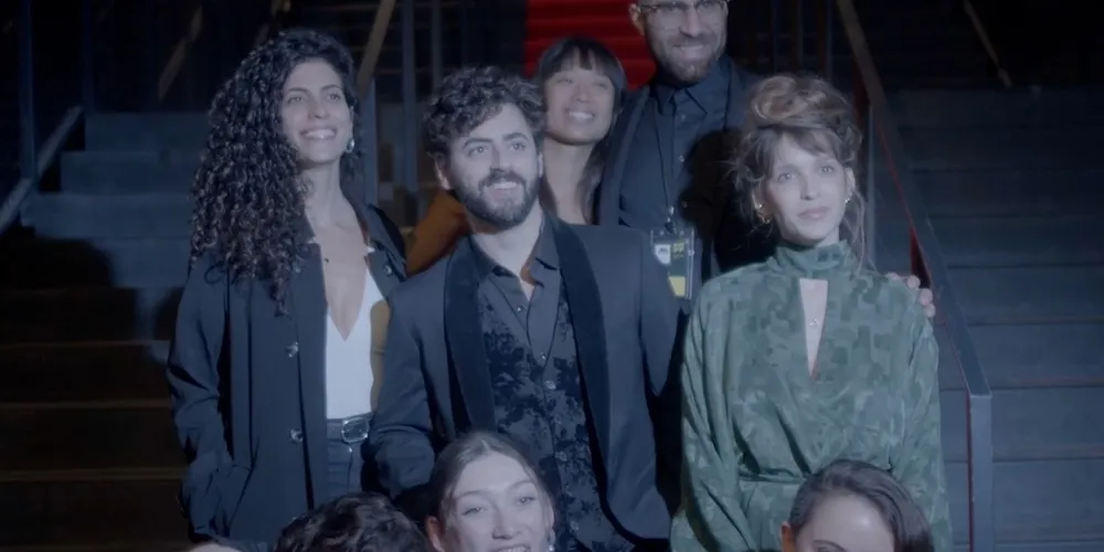 A group of people stand on a set of stairs, smiling