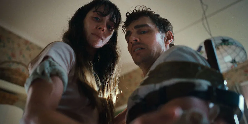 A man and woman look downwards. 