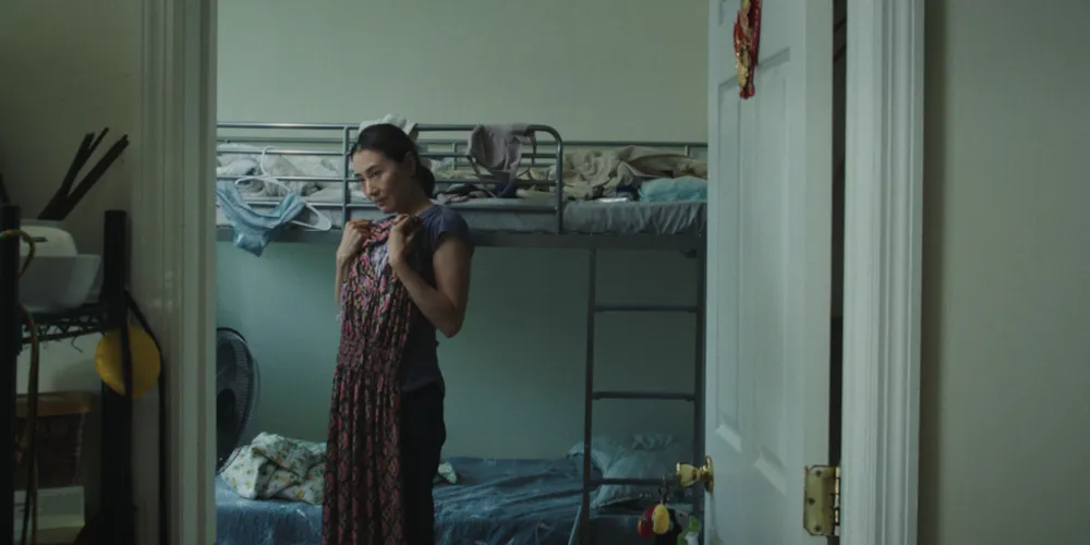 Women tries on dress in room.