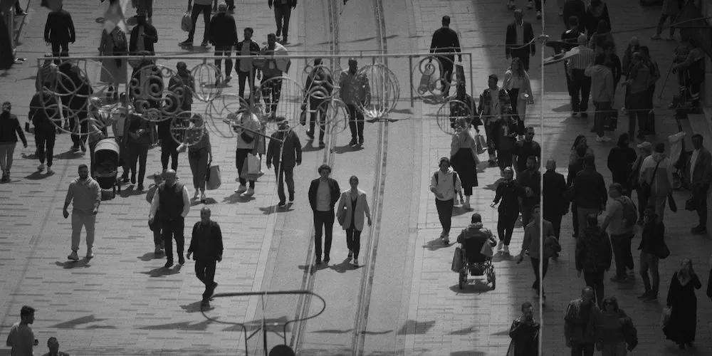 wide shot of people walking around a plaza