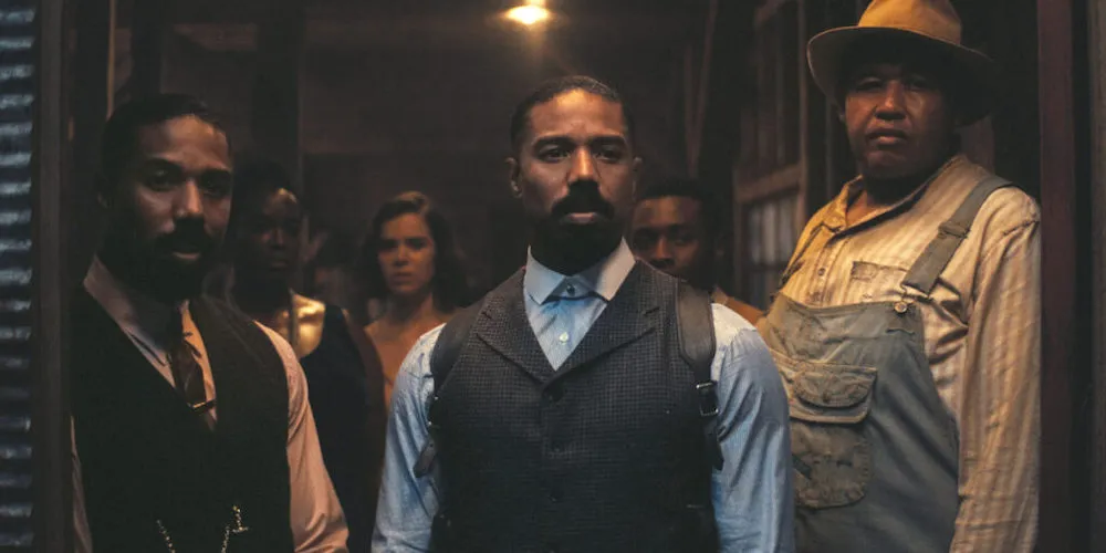 a group of people stand in a doorway looking out