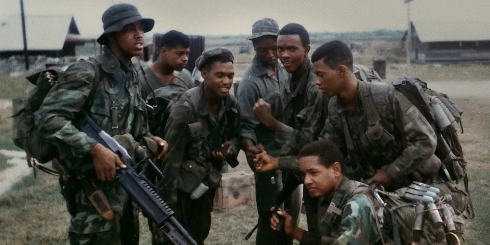 A group of soldiers huddle together. 