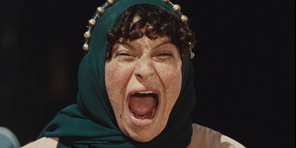 A woman in a headscarf screaming