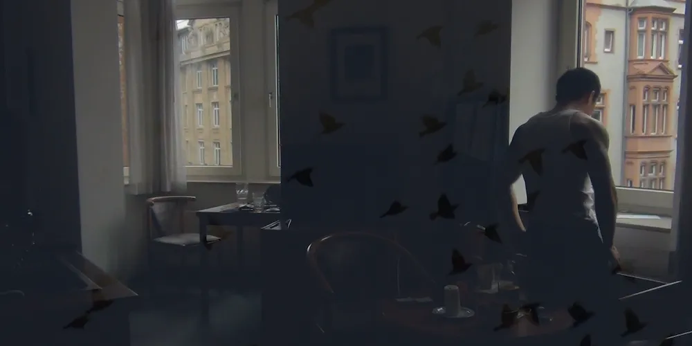still from Goodbye First Love, man looking out a window