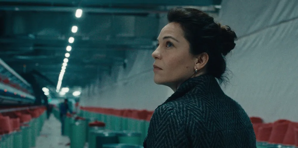 Film still from Hesitation Wound, a woman looking over her shoulder