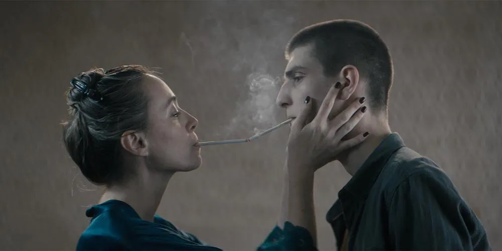 film still, two people smoking 