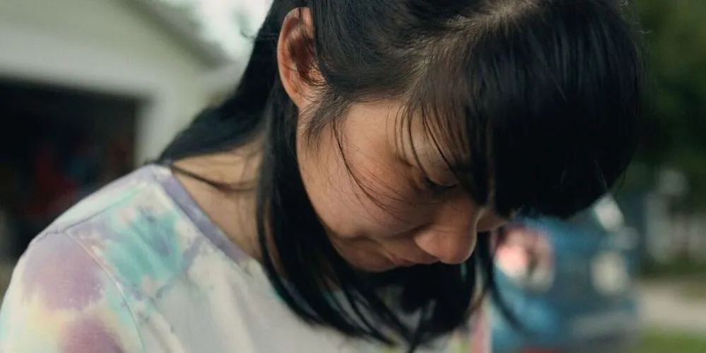 close-up of a young woman, hair covering her face