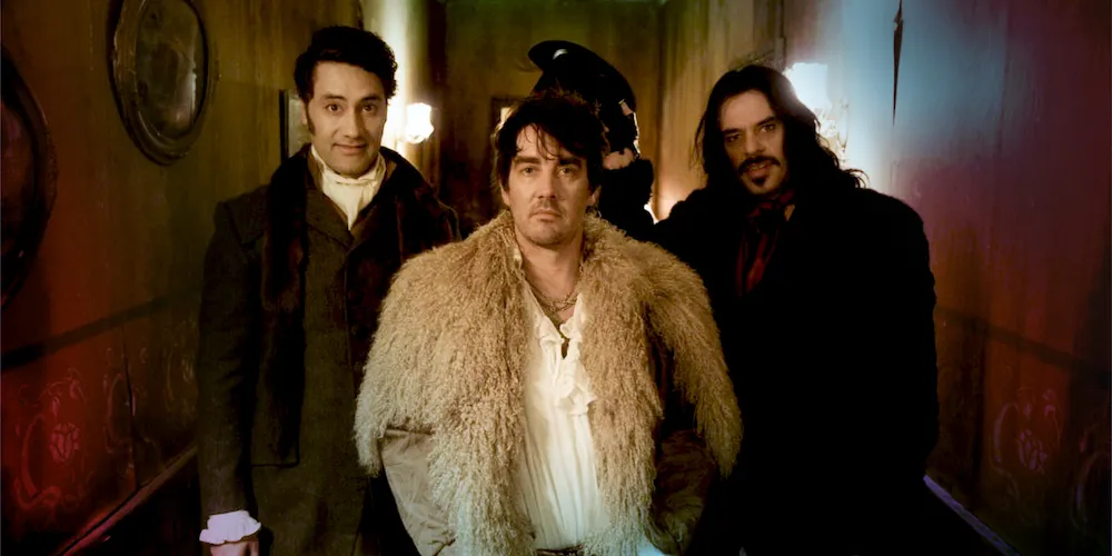Three men in a dark hallway