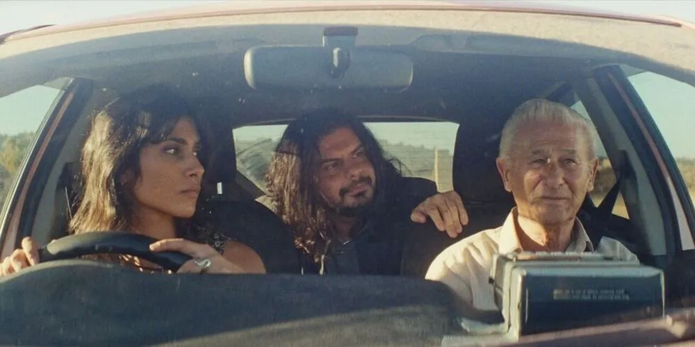three people drive in a car