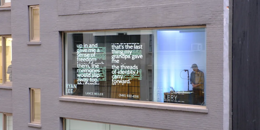 exterior of a building, words projected onto the window