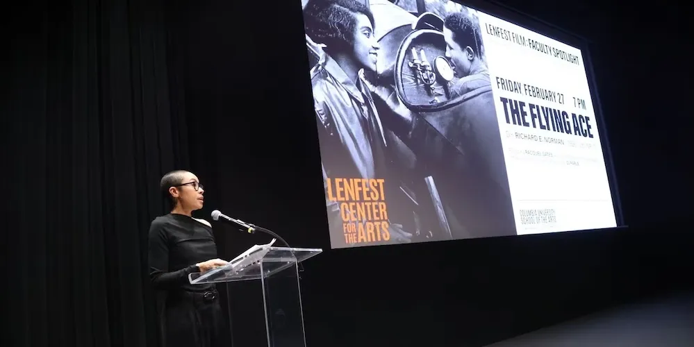 a professor speaks at a podium