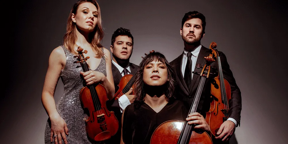 Four musicians posed with stringed instruments