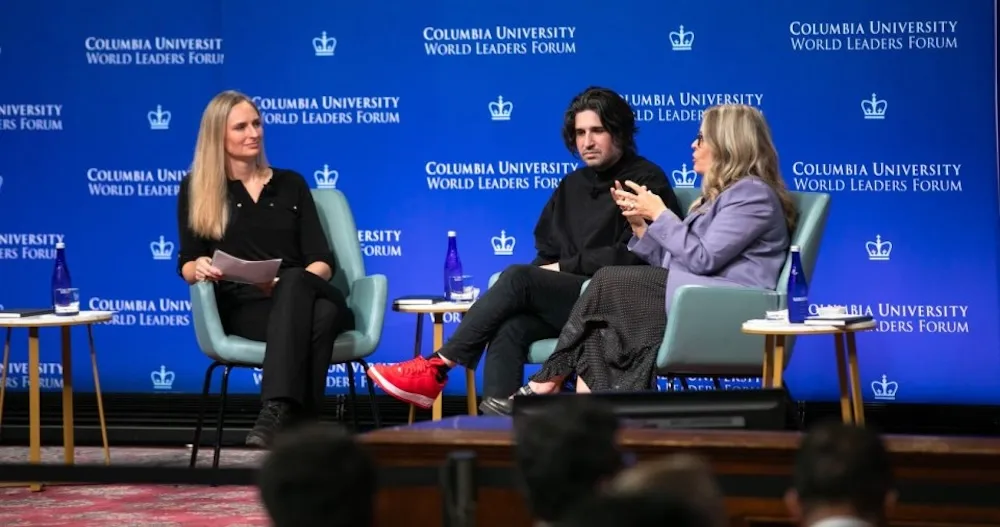 A panel discussion featuring three participants.