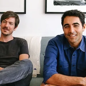Two men sit on a couch