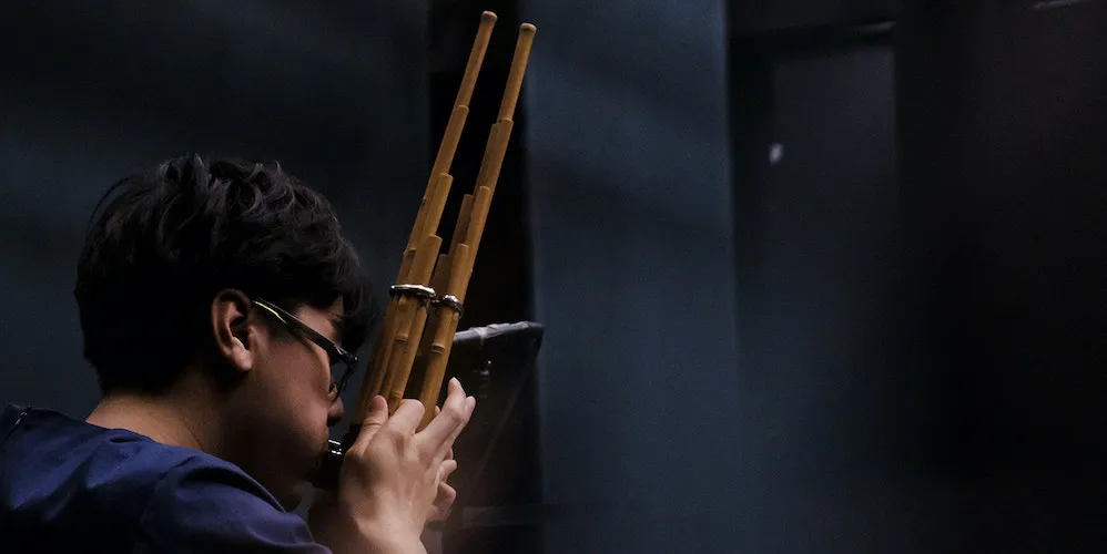Chatori Shimizu plays a wooden wind instrument 