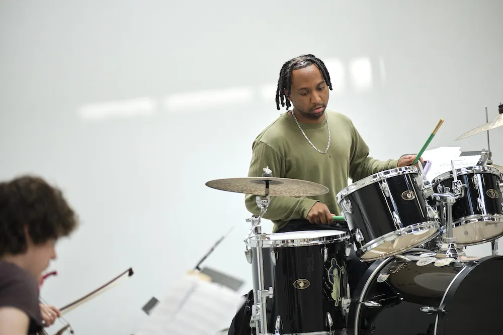 a performer plays the drums