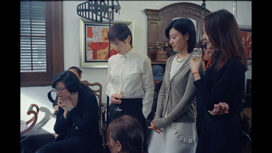 Four women in camera looking out of frame.
