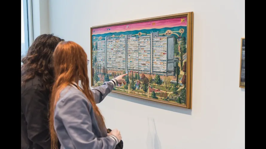 Group of people looking at an art piece.