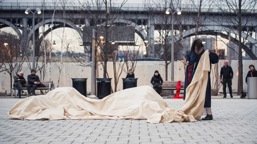 A student artist with a piece of cloth.