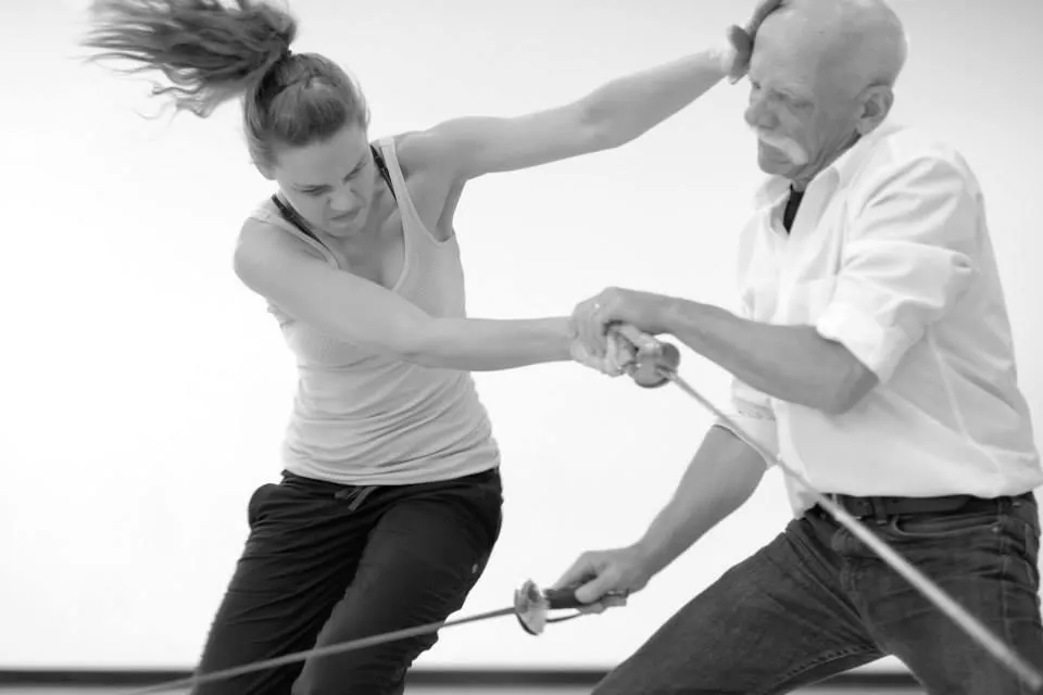 Jacqueline and man action shot holding rapiers