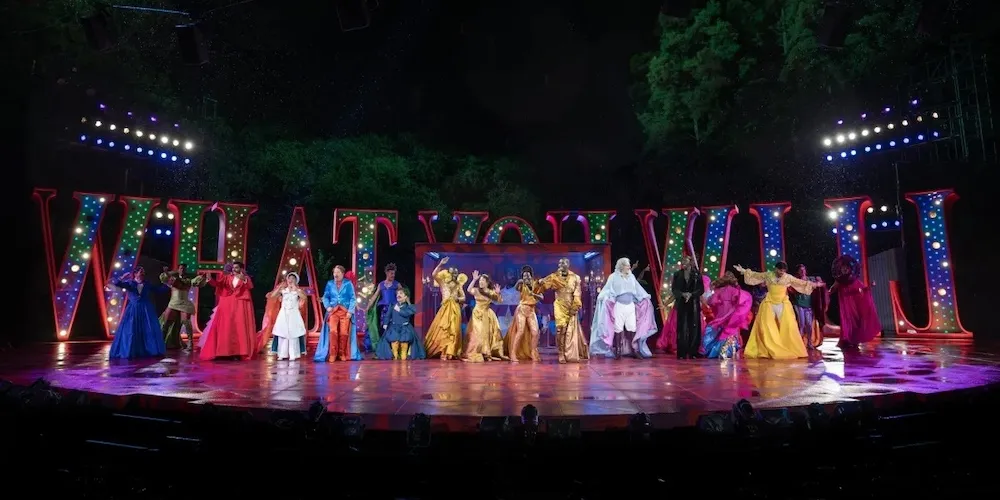 a group of actors on stage outside