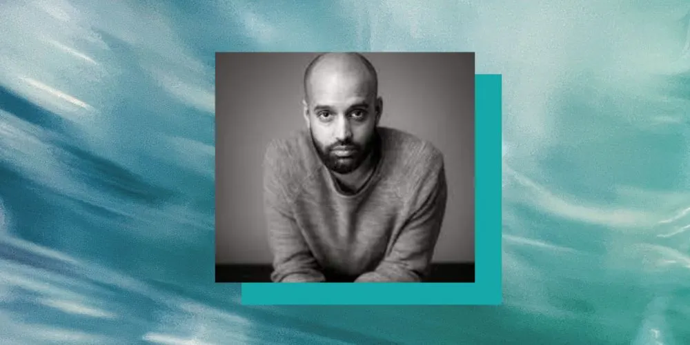 Shayok Misha Chowdhury headshot, blue background