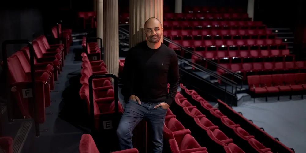A man stands in an empty theater
